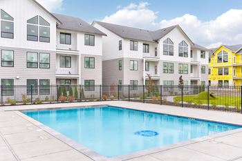 a swimming pool in front of an apartment building